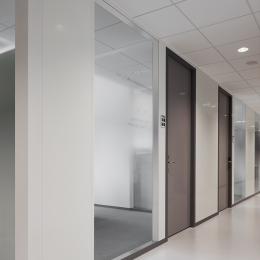 Corridor partition with steel panels and doors combined with glass panels