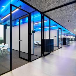 Corridor with glass partition and fire resistant doors at The Flow Houthavens Amsterdam