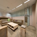 Partitions wall of acoustic laminated glass with wood panels and privacy film added