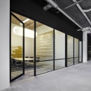Glass partition wall with industrial look & feel from the thirties