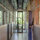 Hallway with glass partitions and door at the end