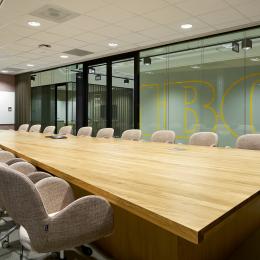 Within the meeting room with glass partition walls of QbiQ