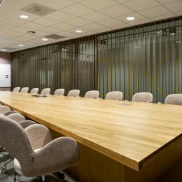 Within a meeting room with curtains in front of glass partition walls of QbiQ