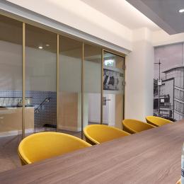 Meeting room with industrial look glass wall in gold colored frame