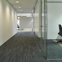 Office wall made of single glass with acoustic foil in between