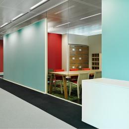 Single glass office wall with acoustic panels attached to the glass