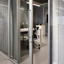 Meeting room with closed blinds and sliding door of QbiQ