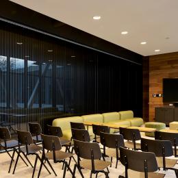 Within a meeting room with closed blinds inside the partition walls of QbiQ