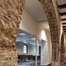 Modern glass wall combined with old stone walls