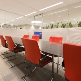 Conference room with single glass wall and wood panels