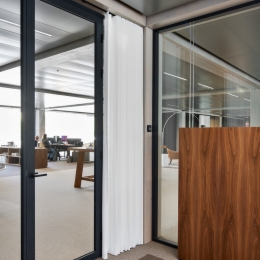 Glass partition with black profiles.