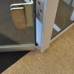 Drop seal under a tempered glass door